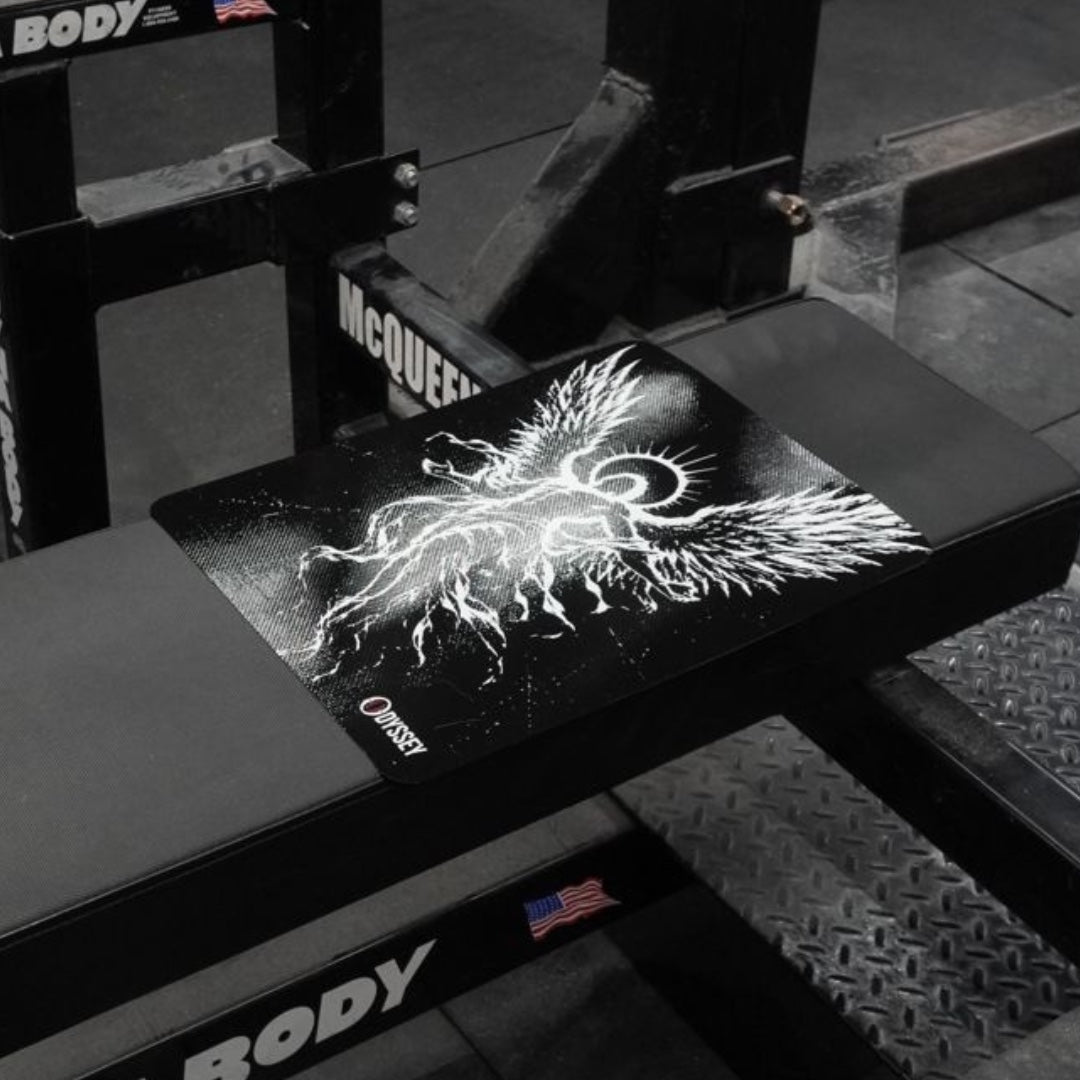 The Icarus Bench Mat in place on a flat bench in the gym, seen from the side