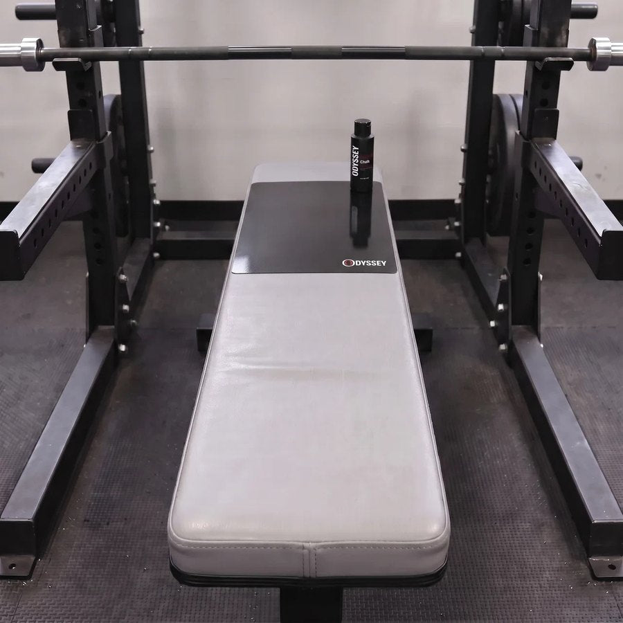 Odyssey Bench Mat V2 on a flat bench in a power rack